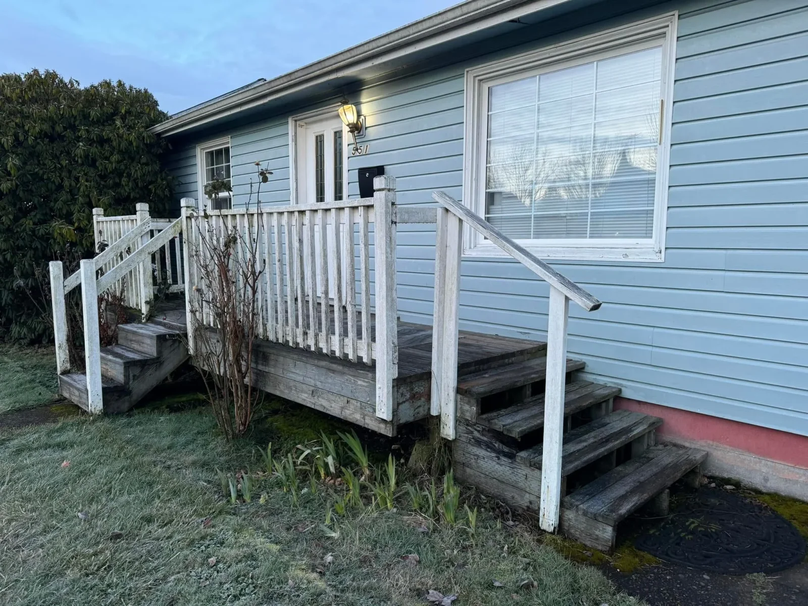 White vinyl deck railing and balusters on front porch with new stairs and handrails