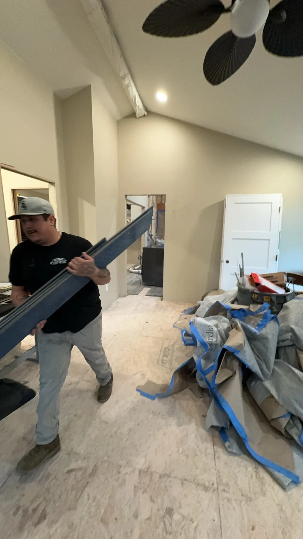 Interior remodeling with painted drywall, recessed lighting, and finished flooring installation in progress