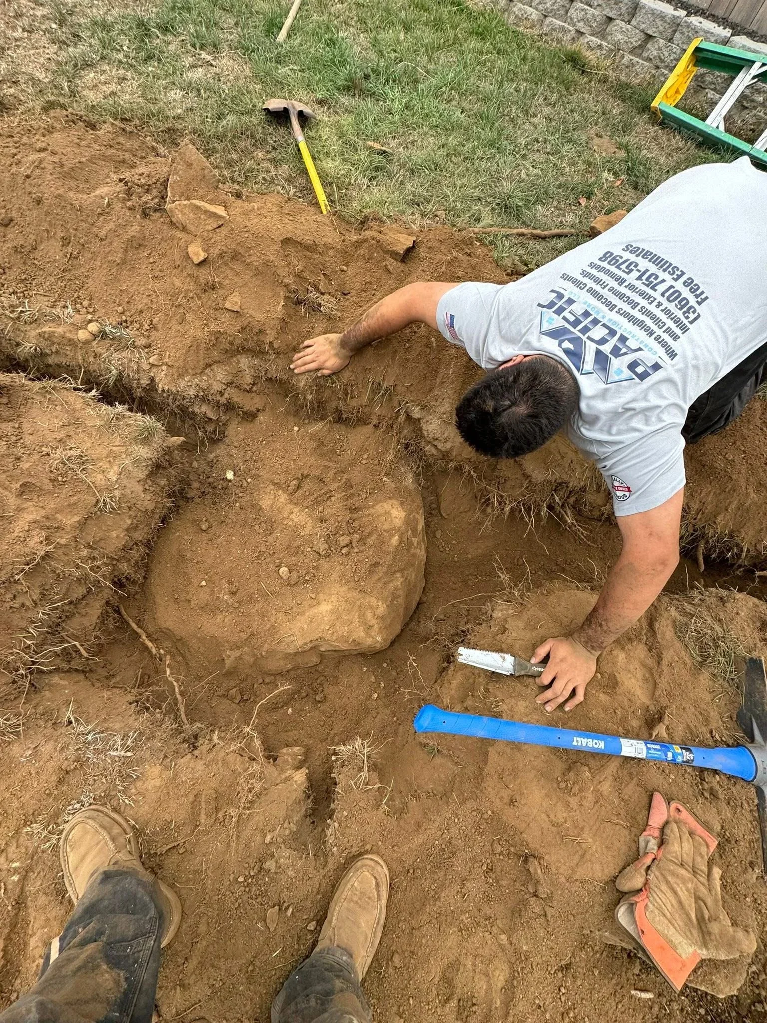 Foundation excavation with soil removal, measuring tools, and site preparation work